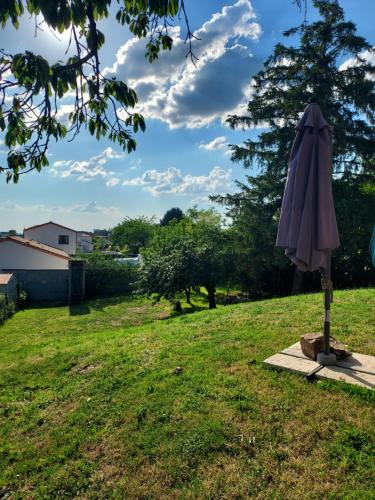an umbrella sitting in the grass in a yard at Garde barrières N 22 in Cholet