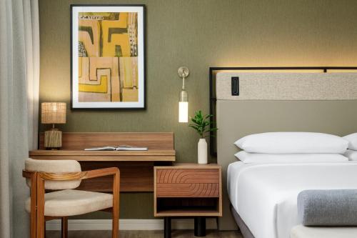 a bedroom with a bed and a desk and a bed and a bed at Hyatt Regency Panama City in Panama City
