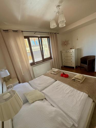 a bedroom with a large white bed and a window at Apartmán Lara -Lesná in Stará Lesná
