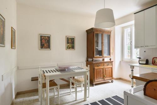 a kitchen with a white table and a wooden cabinet at Un Petit Paradis in Castiglione della Valle