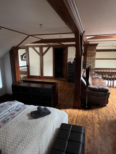 a bedroom with a bed and a chair and a mirror at Apartament Centrum in Augustów