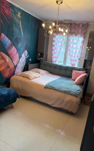 a bedroom with a large bed in a room at La maison du Bonheur 34 in Florensac