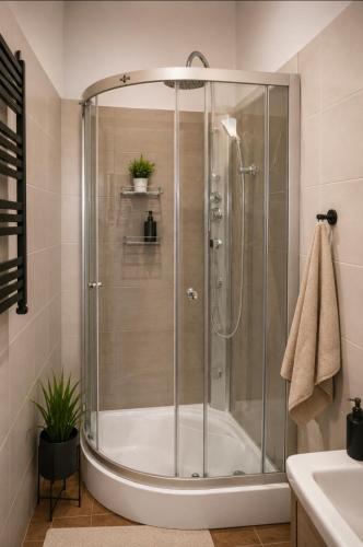 a shower with a glass door in a bathroom at Apartament X in Przemyśl