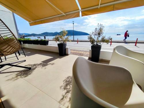 a patio with chairs and a view of the ocean at Aurora suite in Nea Peramos