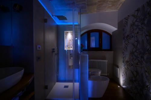 a bathroom with a glass shower and a sink at Charme in Spello in Spello