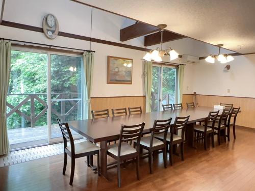 a large dining room with a large table and chairs at ラシェール 伊豆 ガーデンテラス AWA Resort in Ito