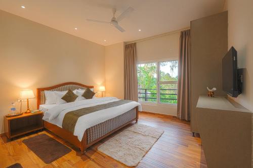 a bedroom with a bed and a large window at Reejas inn's n' suites in Kasauli