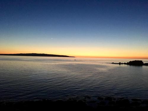 a sunset over a body of water at B&B BentueMari in Portoscuso