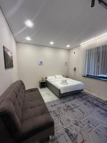 a bedroom with a bed and a couch at Sherpa space in Almaty