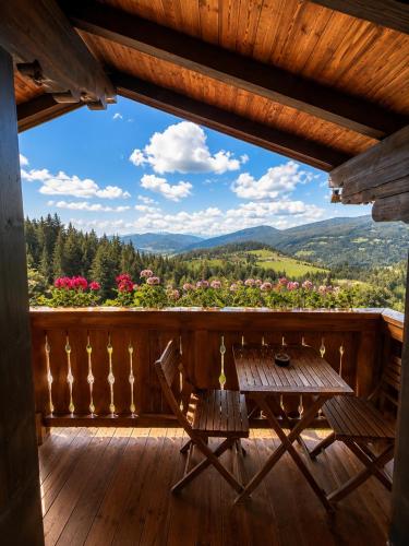 a view from the porch of a cabin with a table and chairs at Frühstückspension Bachseitenhof in Radstadt