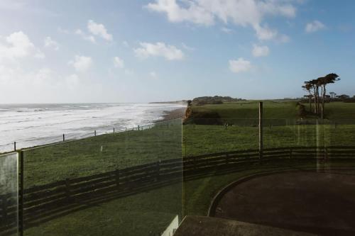 a view of the ocean from a golf course at ABC on Wanaka Bay - beachfront home w. ocean views in New Plymouth
