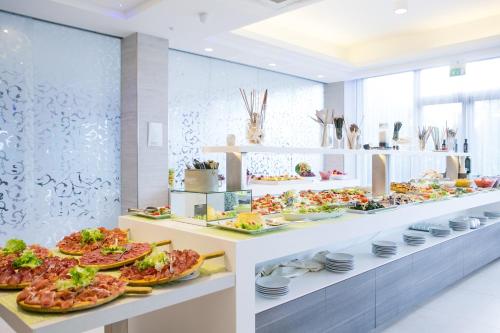 a buffet line with plates of food on display at Hotel Liberty Beach - Parking & Beach in Riccione
