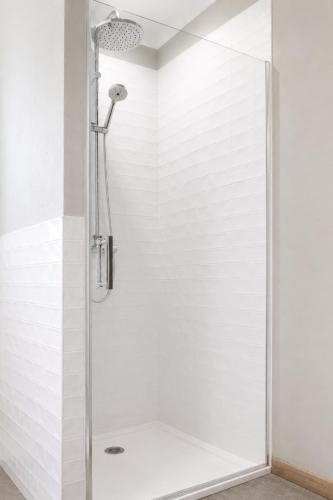 a shower with a glass door in a bathroom at Côté Nuit in Capestang