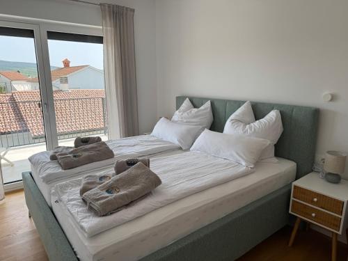 a large bed with towels on it in a room at Villa Quartura in Kornić