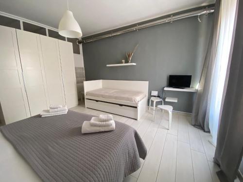 a bedroom with a bed with two towels on it at B&b Kamaraton in Marina di Camerota