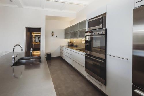 a kitchen with a sink and a stove top oven at The Front Office - charming 3BR heritage home in New Plymouth