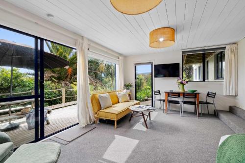 a living room with a couch and a table at Butlers Studio Two in Oakura