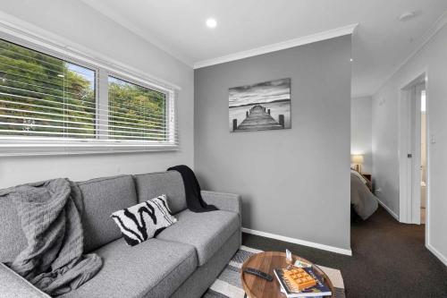 a living room with a couch and a table at Naki Nook - Accommodation Stratford in Stratford