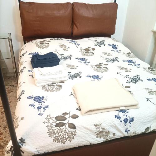 a bed with a blanket and a laptop on it at La Stanza nella corte in Bollate