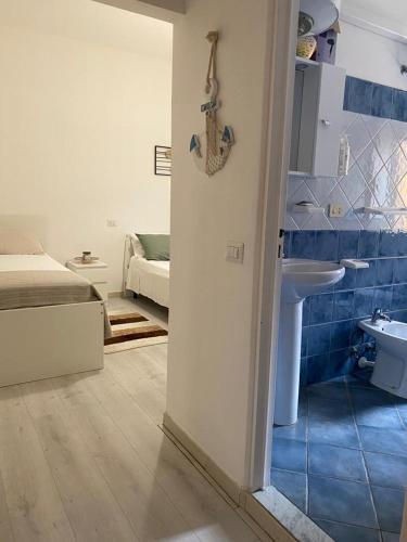 a bathroom with a sink and a bed in a room at B&b Kamaraton in Marina di Camerota