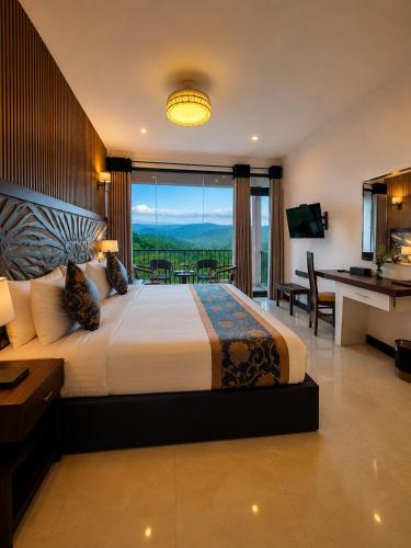 a bedroom with a large bed with a large window at Akway Resort Beragala Haputale in Beragala