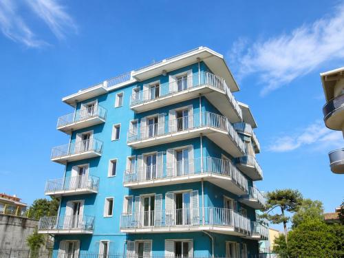 a blue apartment building with white balconies at Condominio Sole - Agenzia Cocal in Caorle