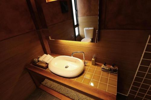 a bathroom with a sink and a mirror at Lana Hotel in Chiang Mai