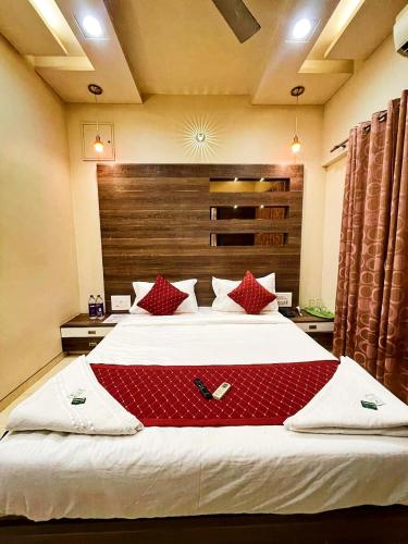a large bed with red pillows in a bedroom at Tejas Grand villa baner in Pune
