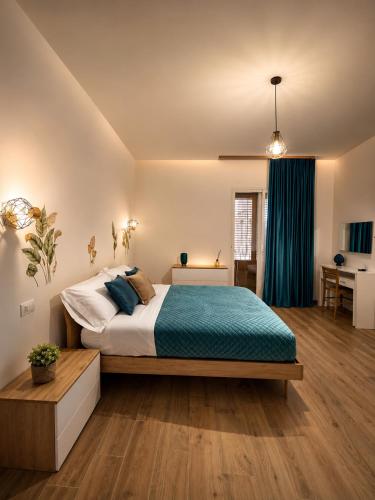 a bedroom with a large bed with a blue blanket at Sicily Luxury Apartments in Palermo