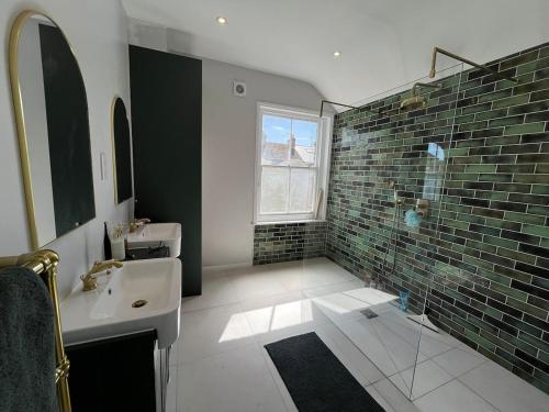a bathroom with a sink and a shower and a window at Number 29 in Melcombe Regis