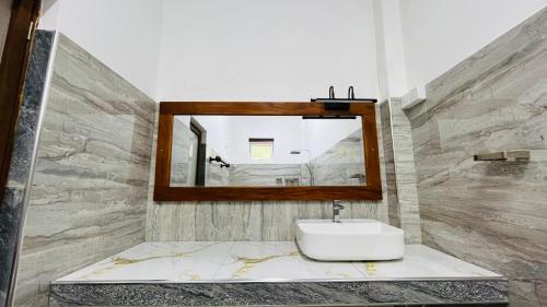a bathroom with a sink and a mirror at Sigiriya Moonlight Home in Sigiriya