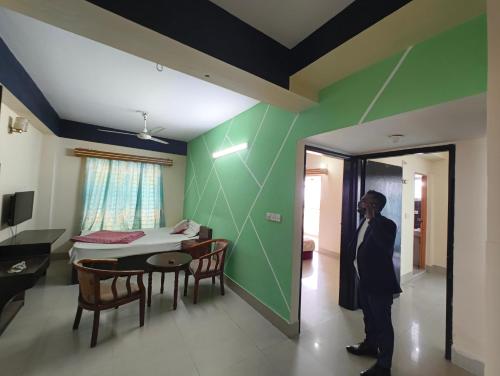 a man is talking on a phone in a room at Hotel World Beach Resort in Cox's Bazar
