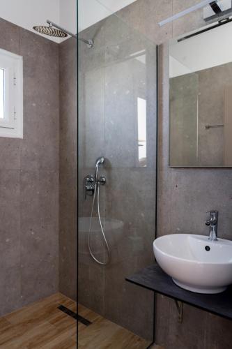 a bathroom with a sink and a glass shower at Cactus in Skiathos