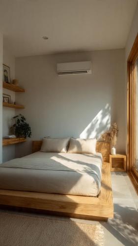 a bedroom with a bed with a wooden frame at the ockta omeah 2 in Semenyih