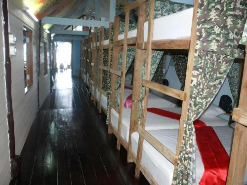 a group of bunk beds in a room at Peacock Hostel in Ko Lanta