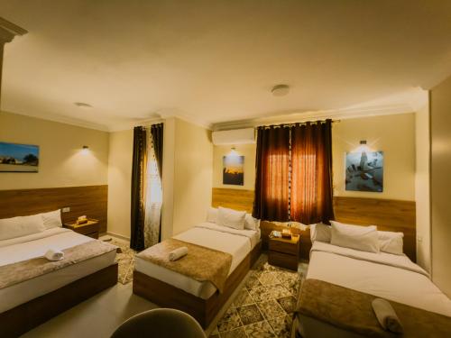 a hotel room with two beds and a window at Nigmt Siwa Hotel in Siwa