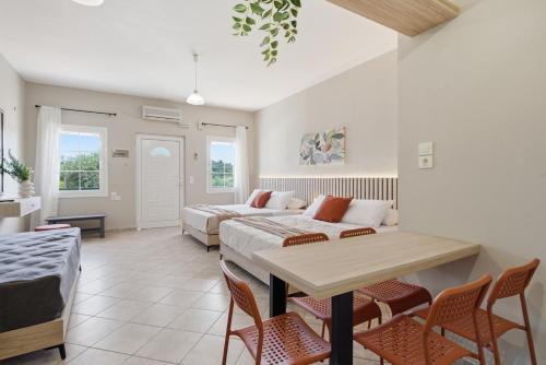 a living room with a bed and a table and chairs at Sivotahomes - Noah in Syvota