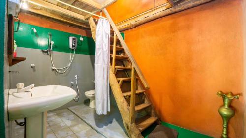 a bathroom with a staircase leading up to a shower at Sigiriya River Side Villa in Sigiriya