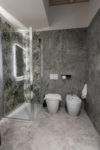 a bathroom with a shower and a toilet and a sink at Retrait Lake Como Private Design Retreat with Lake View in Perledo