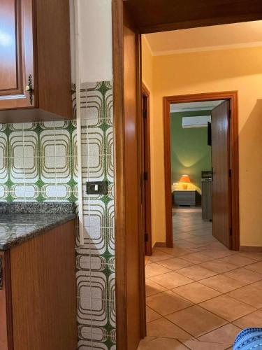 a hallway leading to a room with a bedroom at Le case di Helga in Budoni