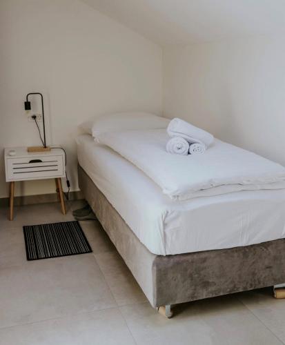 a bedroom with a bed with two towels on it at Lovačka kuća Mandičevac in Mandičevac