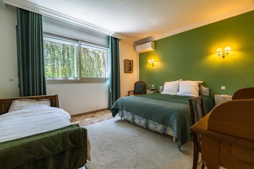 a bedroom with two beds and a window at Villa Montplaisir 180m² - Jacuzzi in Charmes-sur-Rhône