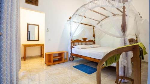 a bedroom with a bed with a canopy at Sigiriya River Side Villa in Sigiriya