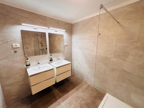 a bathroom with a sink and a shower at Hotel Pohorje in Maribor