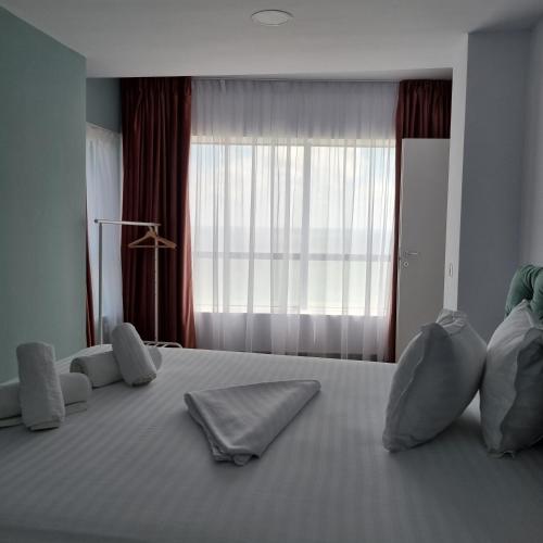a bedroom with a large bed with two pillows on it at Olimp Panoramic Sea View in Olimp