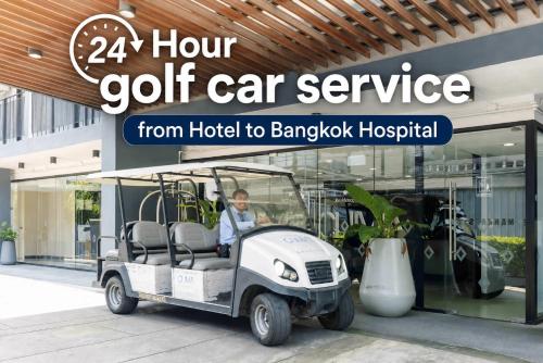 a golf cart parked in front of a store at Chiva Bangkok Hotel in Bangkok