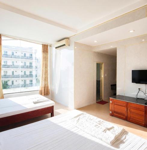 a hotel room with a bed and a television at King Hotel Sầm Sơn in Sầm Sơn