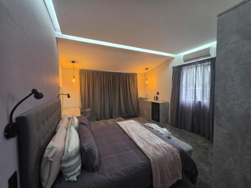 a bedroom with a large bed in a room at Terra Nova Suites and Spa in Gqeberha