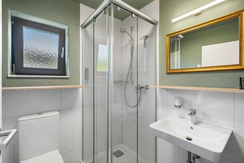a bathroom with a shower and a sink at Das BRIX I Apartments zwischen See & Wald in Immenstaad in Immenstaad am Bodensee