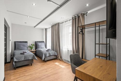 a bedroom with two beds and a table at Central Platinum Apartments 13 in Rybnik